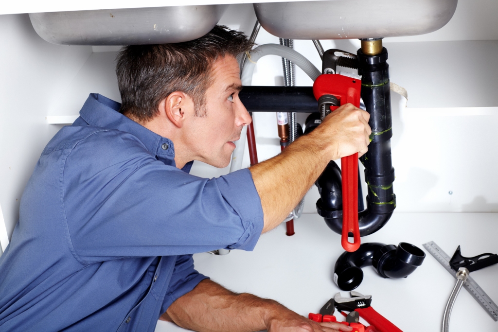 bigstock-Young-smiling-plumber-fixing-a-44301751